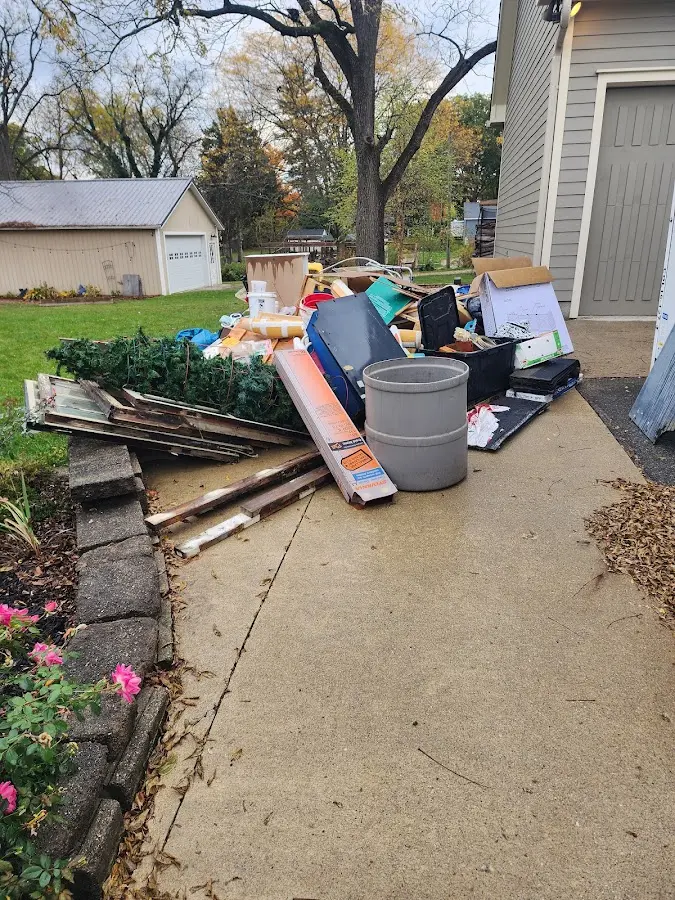 Dumpster being loaded with debris for Roofing Dumpster Rental in Hiawatha